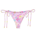 Relax poolside in the Indica Magica String Bikini Bottom, featuring vibrant prints and adjustable ties for the perfect fit.