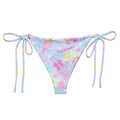 Colorful Indica Magica String Bikini Bottom featuring adjustable straps, perfect for poolside relaxation and sunbathing.