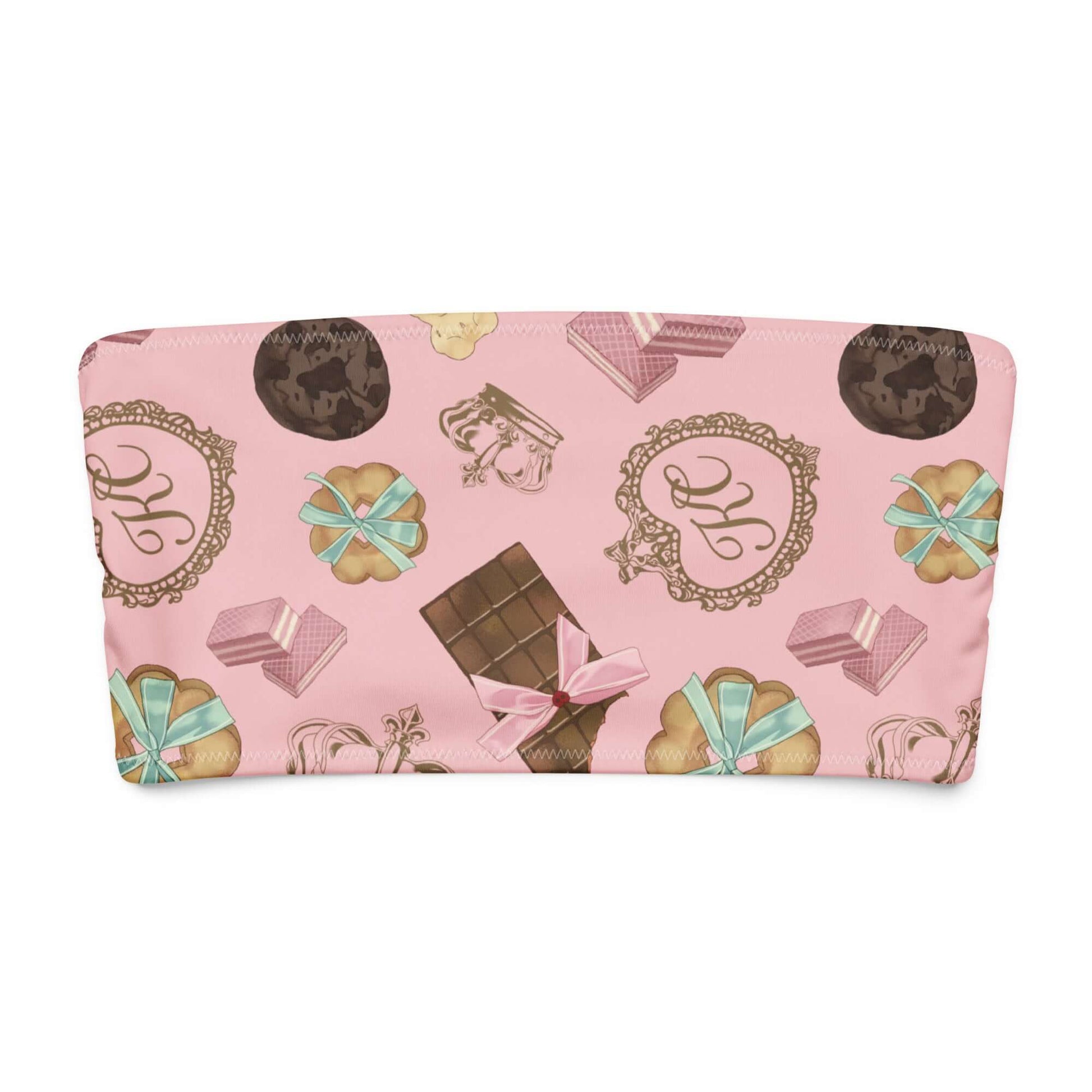 Royal Cookie bandeau bikini top with pastel pink background and playful dessert patterns.