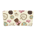 Playful bandeau bikini top featuring an assortment of chocolates and sweets design on a cream background.