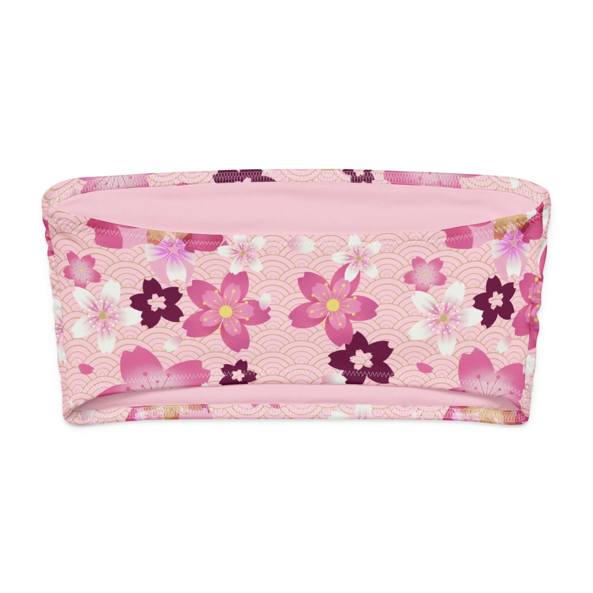Sakura bandeau bikini top featuring soft pink fabric with vibrant floral print, perfect for sunny days and lounging.