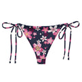 Sakura String Bikini Bottom features a floral design, perfect for sunbathing by the pool this summer.
