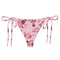 Sakura String Bikini Bottom features a floral design, perfect for sunbathing by the pool this summer.
