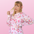 Pastel pink Strawberry Sweatshirt featuring cute fruit designs, perfect for a kawaii aesthetic and cozy comfort.