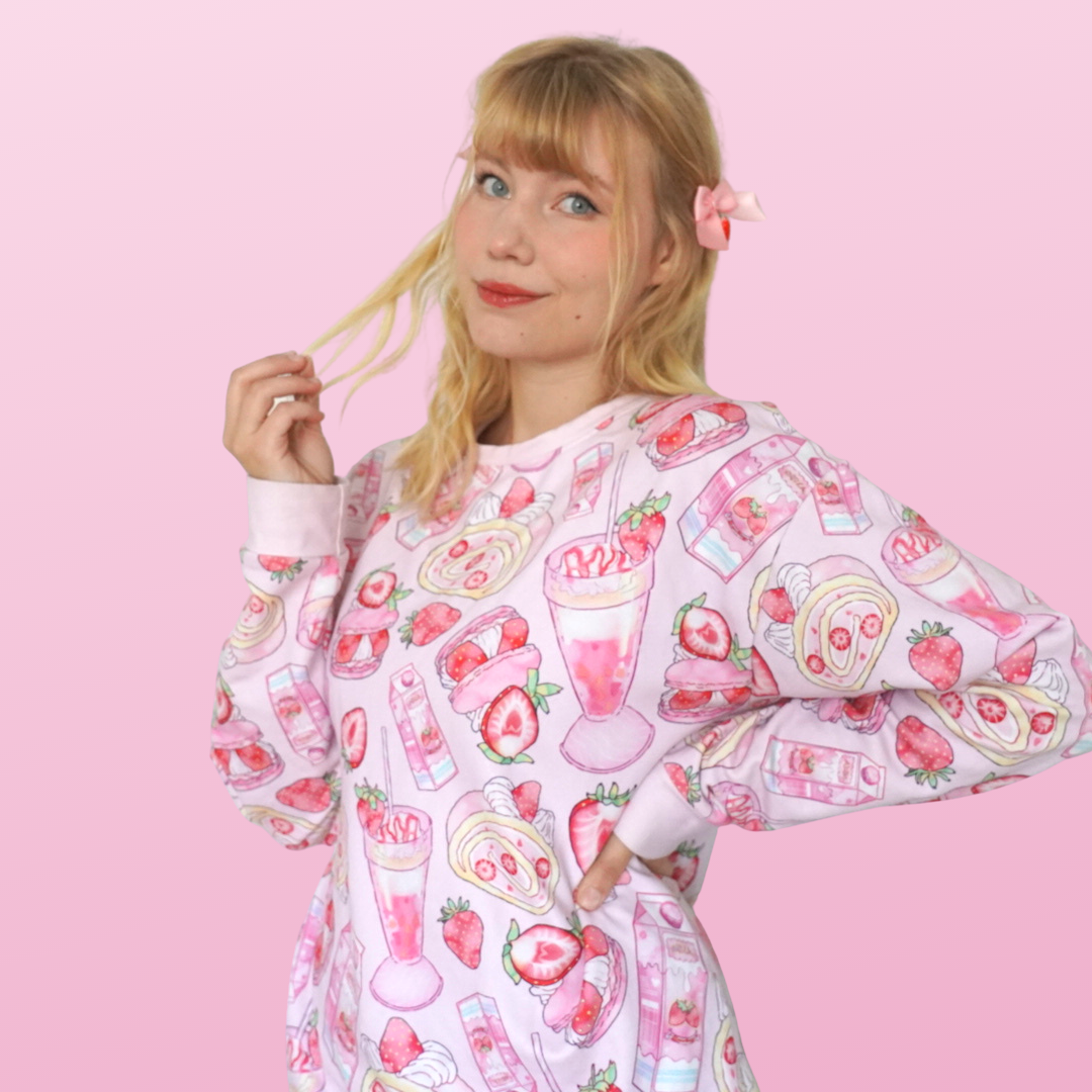 Pastel pink Strawberry Sweatshirt featuring cute fruit designs, perfect for a kawaii aesthetic and cozy comfort.