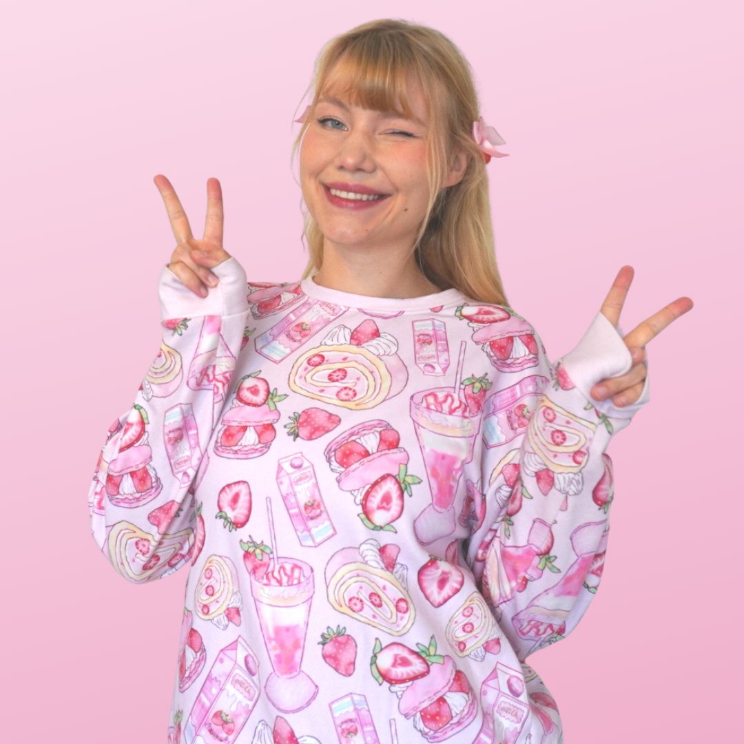 Pastel pink Strawberry Sweatshirt perfect for a kawaii aesthetic, featuring fun fruit designs and cozy fleece inside.