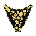 Lemon V-cut bikini bottom featuring fun food and drink prints on a black background, perfect for sunny beach days.