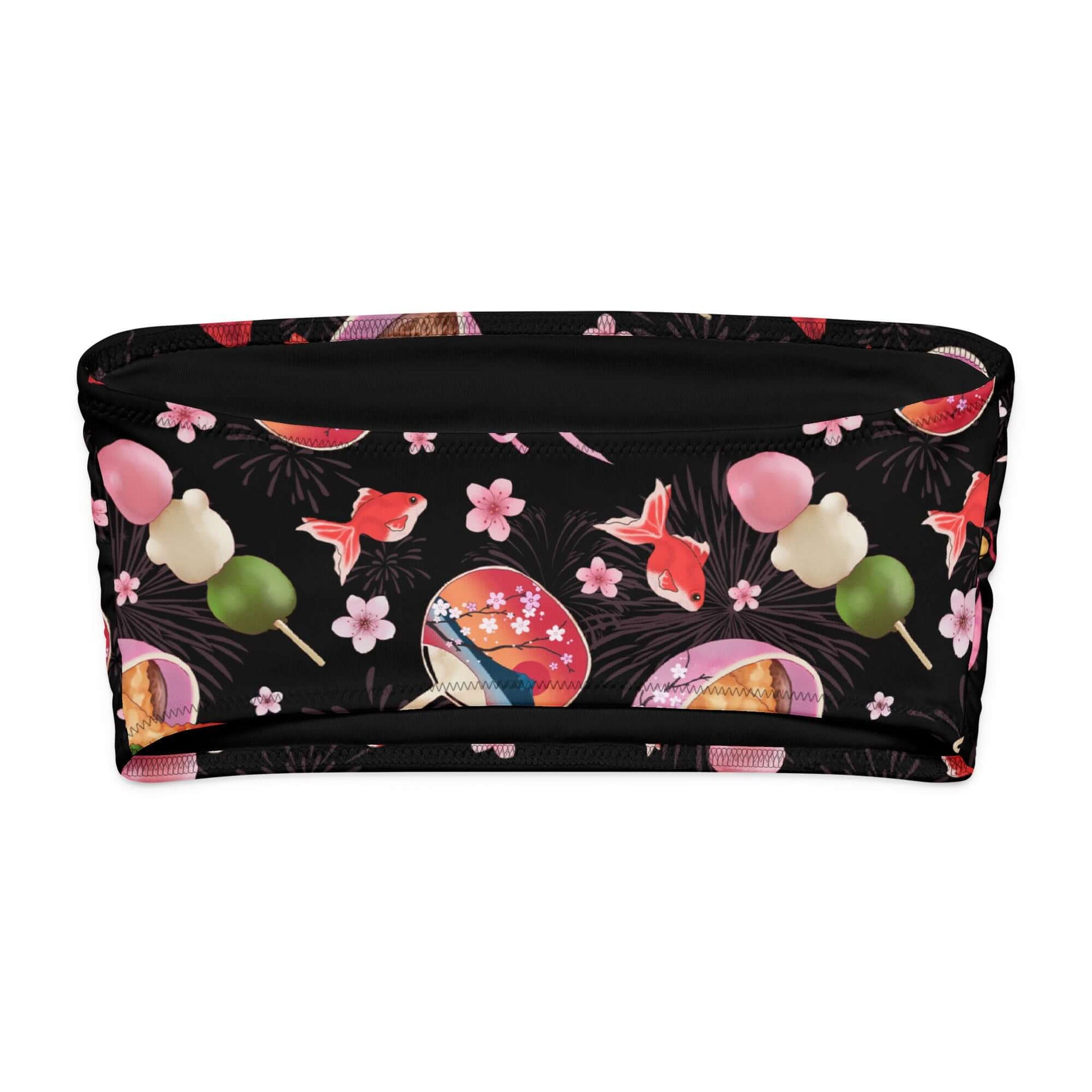Matsuri bandeau bikini top featuring vibrant Japanese festival patterns with goldfish and sweet treats on a black background.