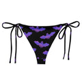 Stylish Morrigan String Bikini Bottom featuring a playful bat print, perfect for poolside relaxation this summer.