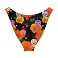 V-cut bikini bottom with colorful sugar skull and floral design on a black background, perfect for sunny days.