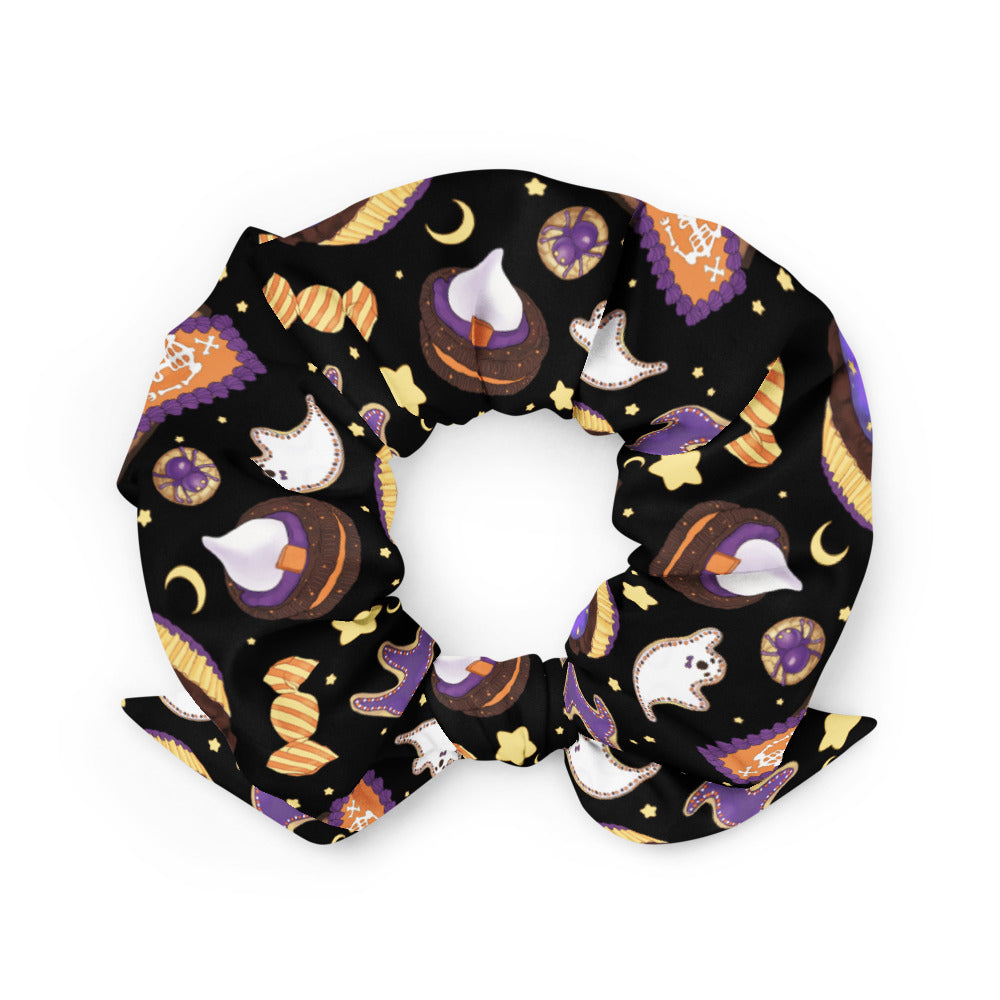 Add a spooky touch to your look with the Halloween Treat Scrunchie, featuring festive candy designs on a black background.