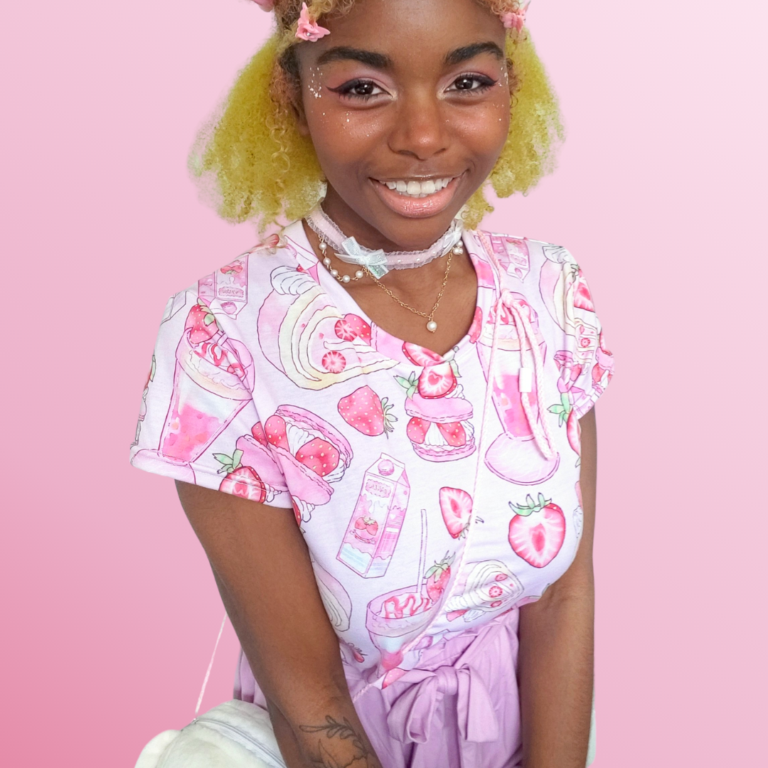 Pretty in pastel pink, the Strawberry Crop Top adds a kawaii touch to your wardrobe, perfect for everyday wear.