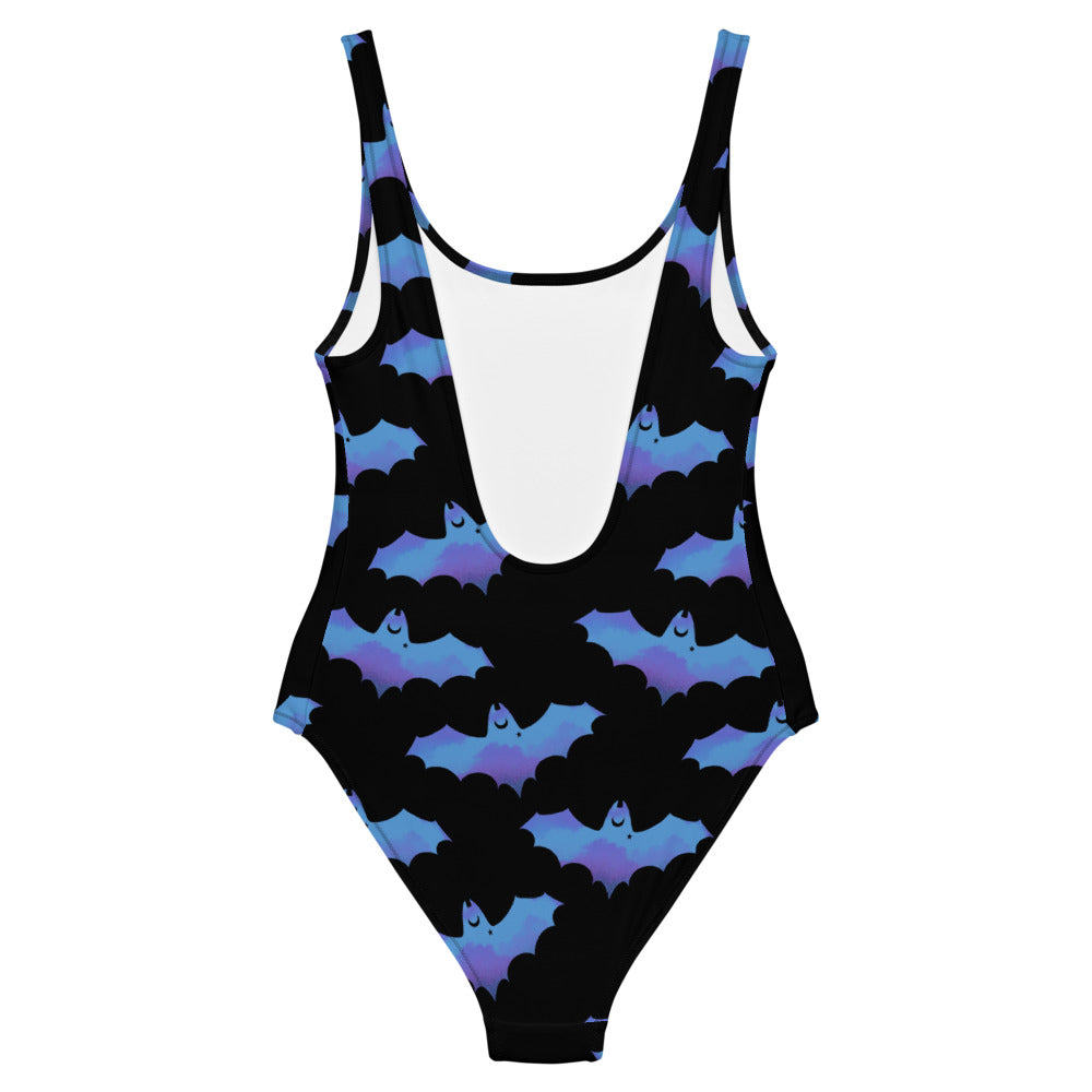 Stylish Lilith One-Piece Swimsuit featuring bats and clouds, perfect for a unique beach look.
