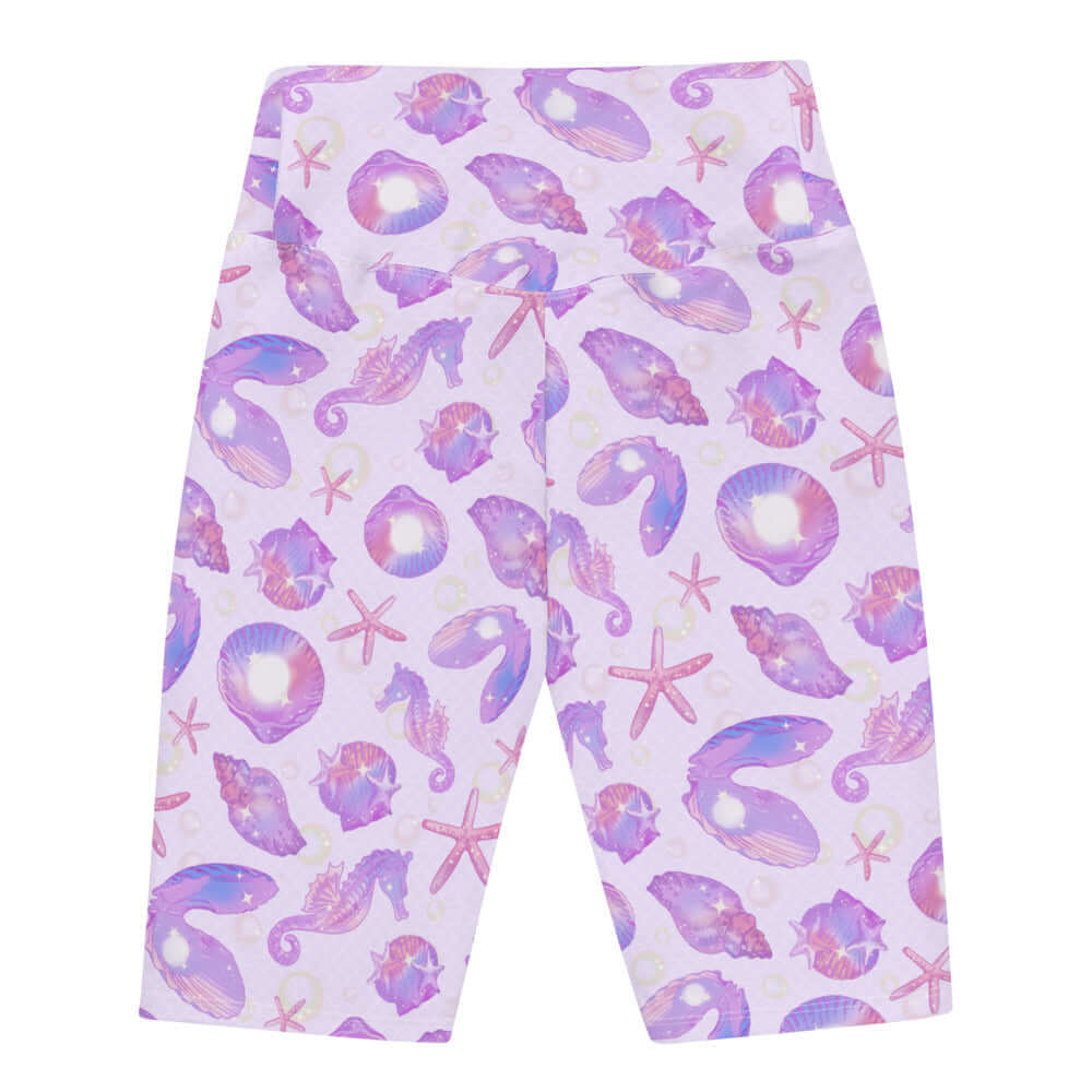 High-waisted Sea Princess Biker Shorts featuring a vibrant seashell print, perfect for summer adventures.