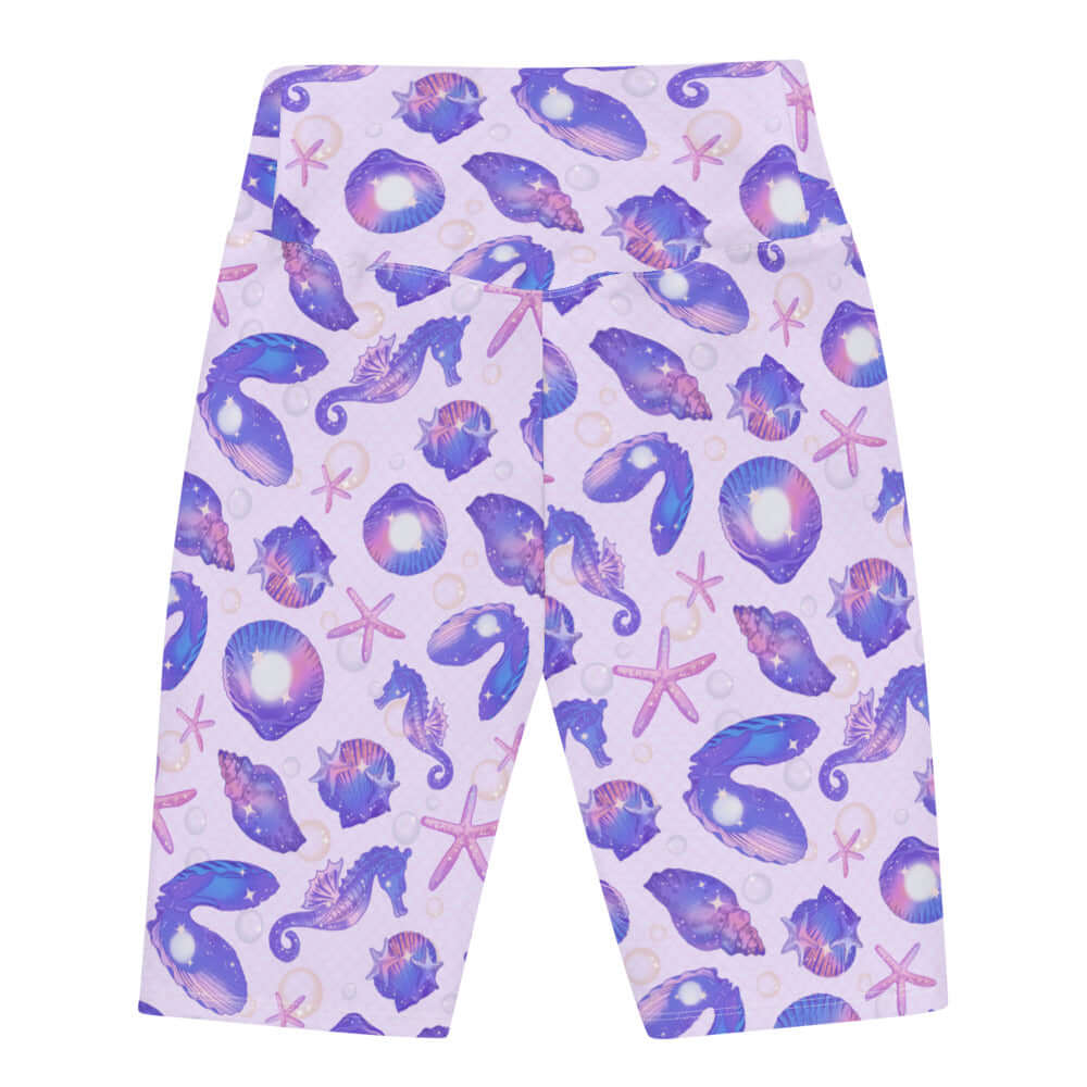 High-waisted Sea Princess Biker Shorts feature a vibrant seashell print, perfect for summer workouts and beach runs.